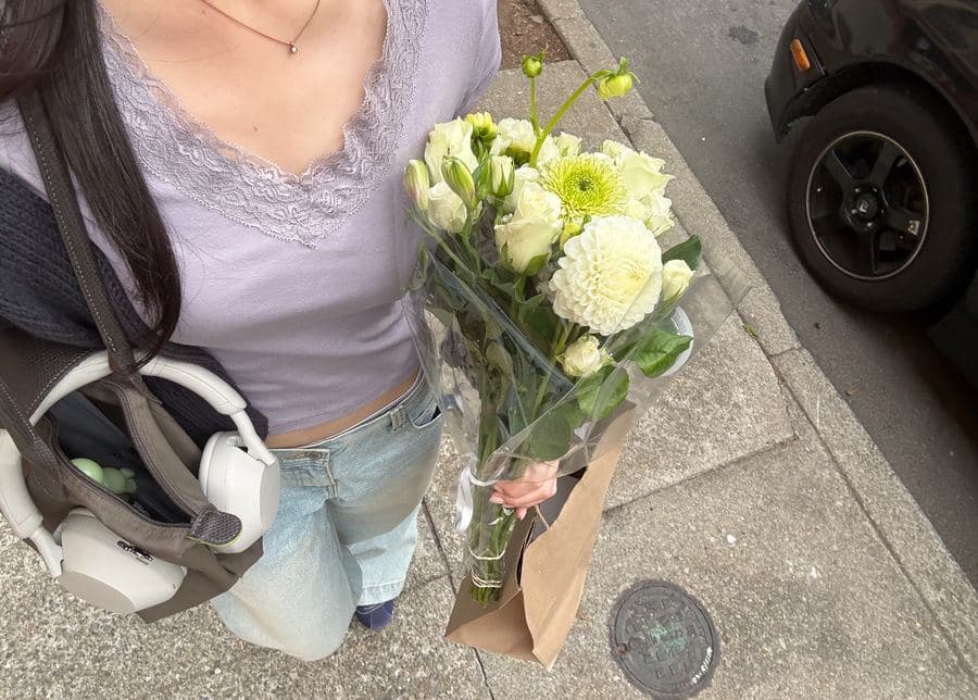 Bella holding a bouquet of white flowers
